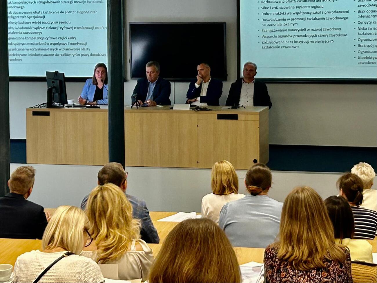 Zdjęcie pokazuje anonimowe ujęcie uczestników konferencji, a drugie tło stanowią: Pan Artur Ostrowski, członek Zarządu Województwa Łódzkiego, Marcin Pawlak dyrektor Biura Planowania Regionalnego Województwa Łódzkiego oraz organizatorzy konferencji.